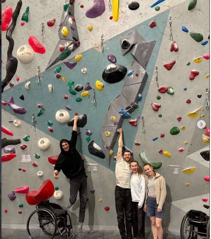 Will Ruane and friends in front of a climbing wall